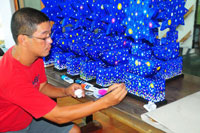 Raymond Legaspi works on the trophies.