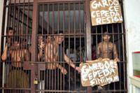 Inmates of the Iloilo Rehabilitation Center (IRC) display placards calling for the ouster of provincial warden Atty. Sotelo Gardoce and provincial guard May Flor Cepeda.