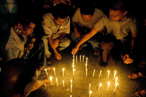 Mediamen in Iloilo City offer prayers and light candles in front of the Bombo Radyo station in Mapa Street