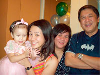 Baby Juliana enjoys the party treat from Mom Jolin and Mama Erlinda and Papa Totong Regalado.