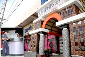 A policeman investigates a security guard of KTV Sandpipers, Jalandoni Street,