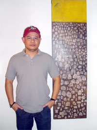 The artist, Joseph 'Tiny' Firmeza with his work Barangay sa Higad Baybay.