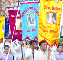 Barangay representatives carrying their religious banners.