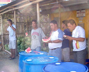 Travelers stop over to eat fresh watermelons being sold beside the road in Zarraga, Iloilo.