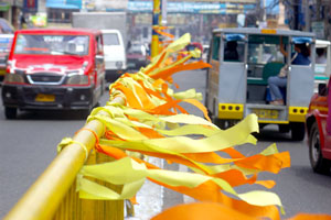 POLITICAL COLORS. Ribbons of yellow and orange line up the streets of Iloilo City