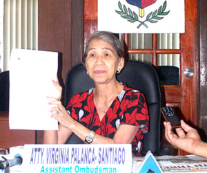 Assistant Ombudsman Virginia Palanca-Santiago shows to reporters the Ombudsman decision finding Iloilo Governor Niel Tupas Sr.