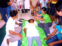 A volunteer demonstrates a rehabilitation technique.