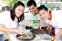 LG executives prepare foods for the Iloilo house guests.