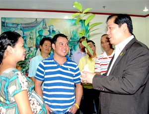 PLANT A TREE, GET MARRIED. Iloilo City Mayor Jed Patrick Mabilog gives a seedling to a couple to be planted at the Calajunan open dump in Mandurriao district