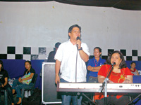 Vice Mayor Joe Espinosa III serenades the top 10 outstanding PWDs with Marisa Montelibano at the keyboard.