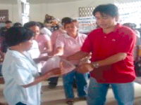 The youngest mayor of Capiz distributes goods to the indigents of his town.