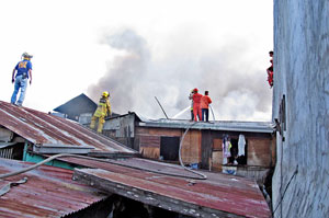 Smoke billows from the fire that destroyed 53 houses