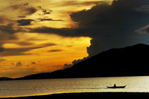 A fisherman sails home on a cloudy afternoon in Concepcion, Iloilo.