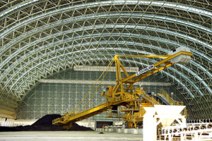 A machine scatters the fossil coal inside the huge storage area of the Panay Energy Development Corp.