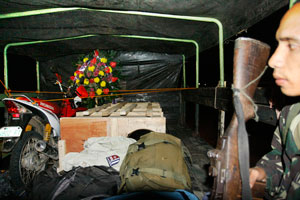 A soldier guards the remains of Staff Sgt. Rey Palomaria, 42, of Brgy. Man-it, Passi City